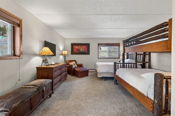 a bedroom with two beds and painting on the wall