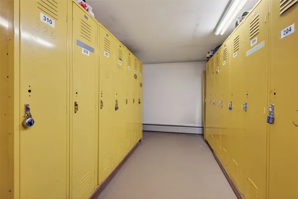 a room with lots of books and white walls