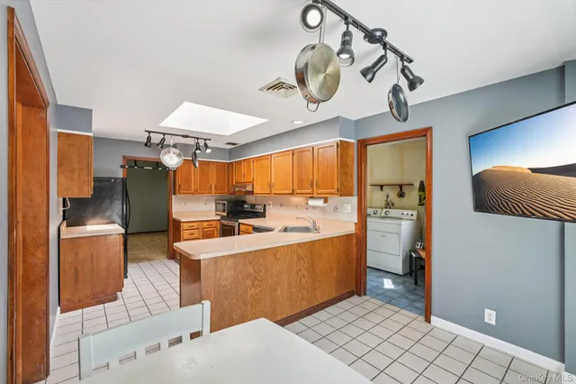 a kitchen with stainless steel appliances kitchen island granite countertop a sink and cabinets