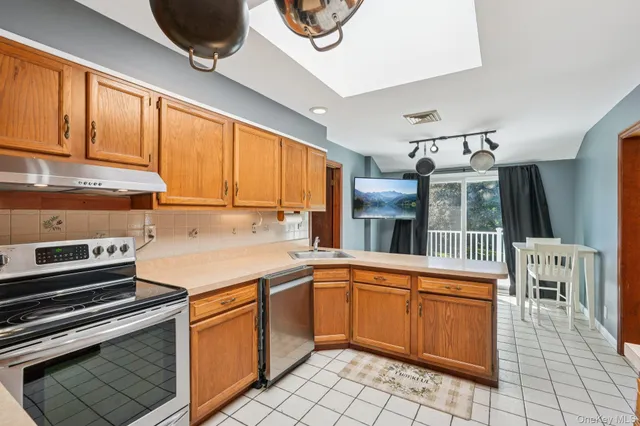 a kitchen with a sink appliances and cabinets