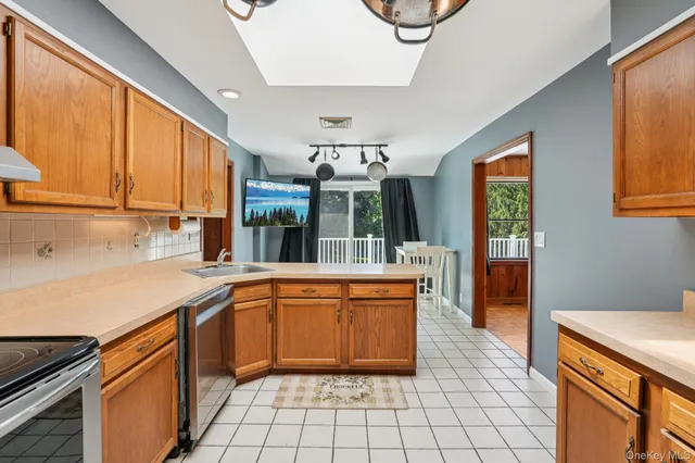 a kitchen with stainless steel appliances a sink and a refrigerator