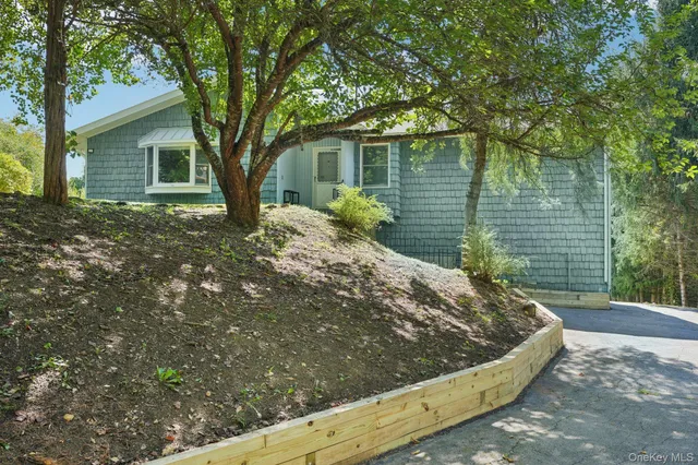 a view of a house with a tree in the background
