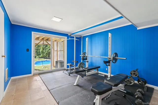 a room with gym equipment and a large window