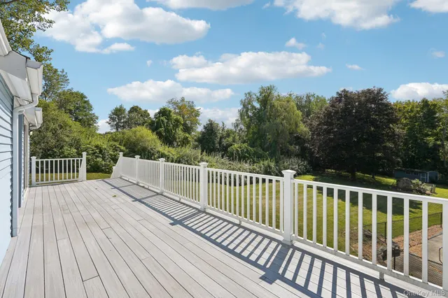 a balcony with wooden floor and fence