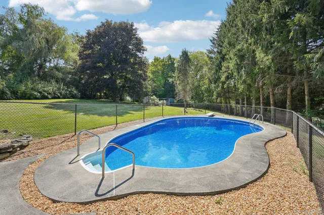 a view of a swimming pool with a yard