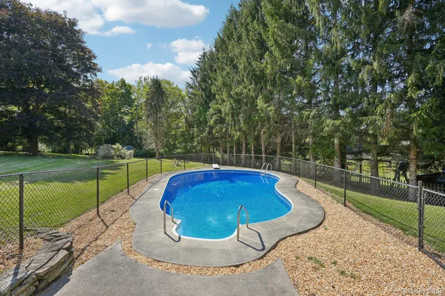 a view of a backyard with wooden fence