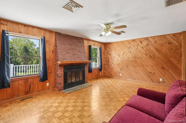 a living room with furniture a fireplace and a flat screen tv