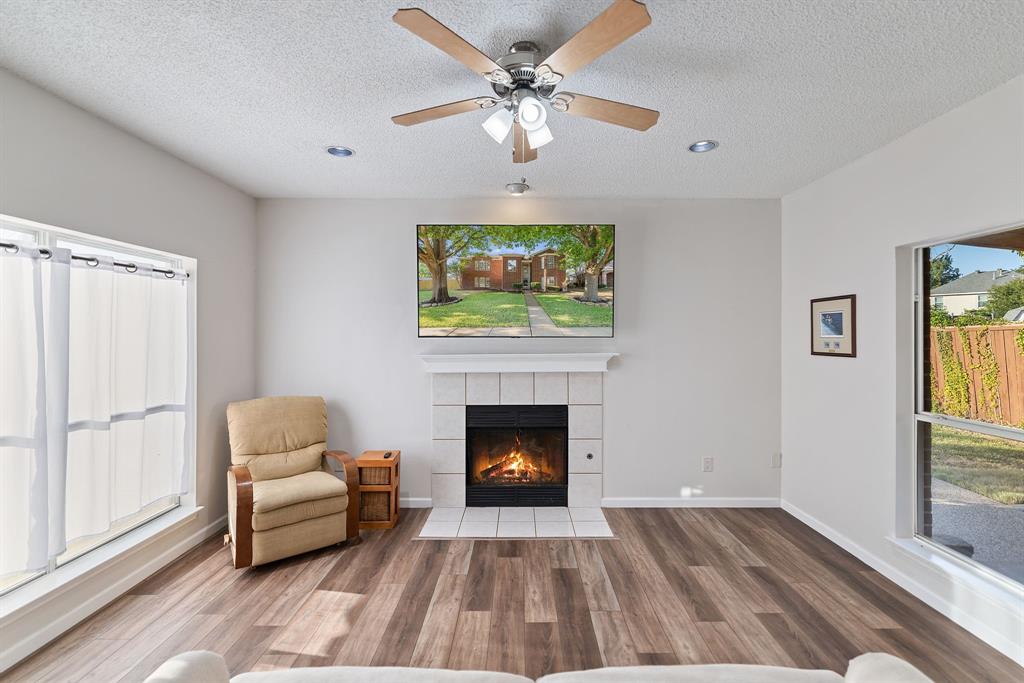 750 Pulitzer Lane Allen, TX 75002 - Photo 17 of 40 a living room with furniture and a fireplace