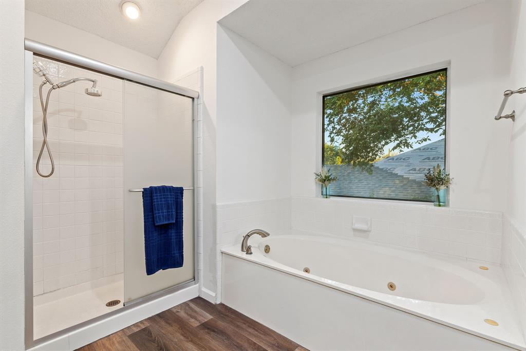 750 Pulitzer Lane Allen, TX 75002 - Photo 25 of 40 a bathroom with a bathtub and a shower