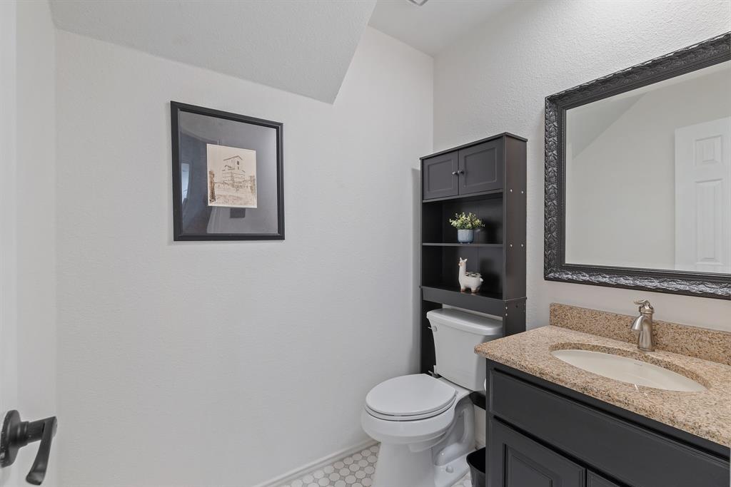 750 Pulitzer Lane Allen, TX 75002 - Photo 7 of 40 a bathroom with a granite countertop toilet sink and mirror