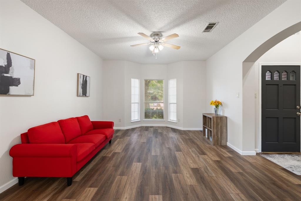 750 Pulitzer Lane Allen, TX 75002 - Photo 9 of 40 a living room with furniture and a chandelier