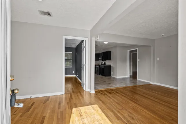 a view of a living room with wooden floor