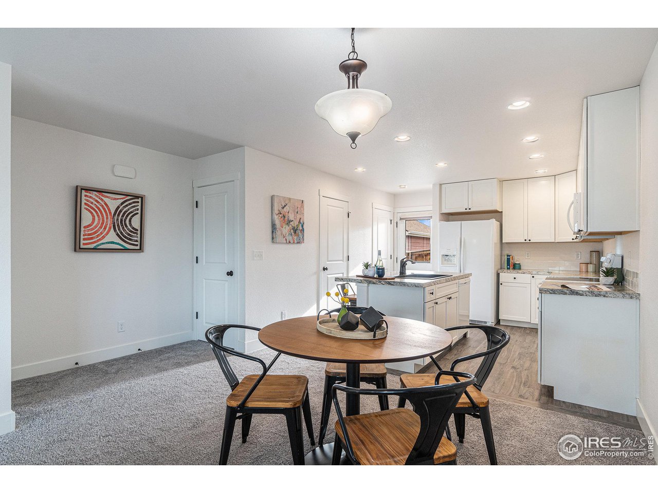 2771 Red Wheat Trail Berthoud, CO 80513 - Photo 11 of 24 a view of a dining room with furniture and wooden floor