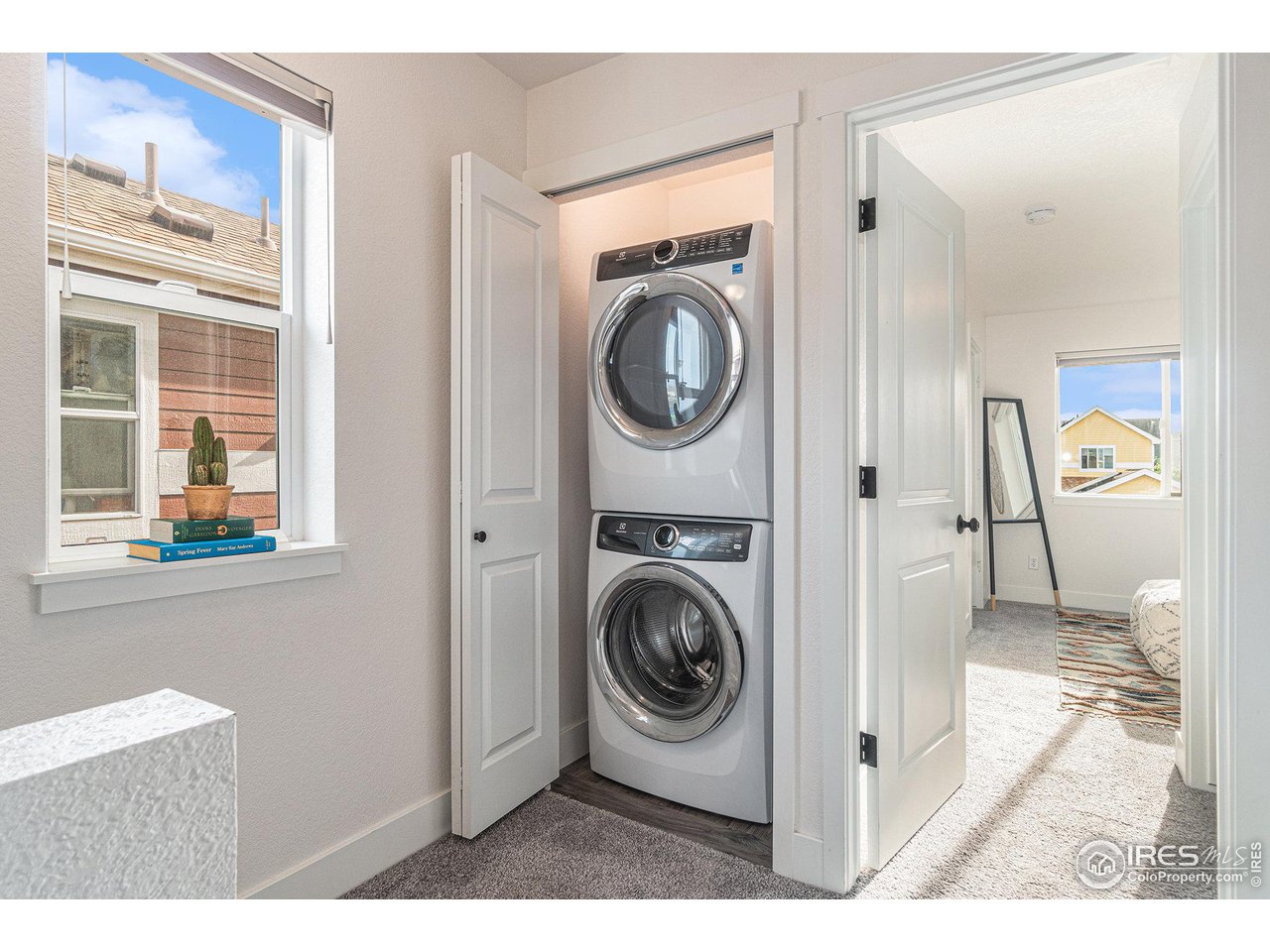 2771 Red Wheat Trail Berthoud, CO 80513 - Photo 12 of 24 a view of a hallway with washer and dryer
