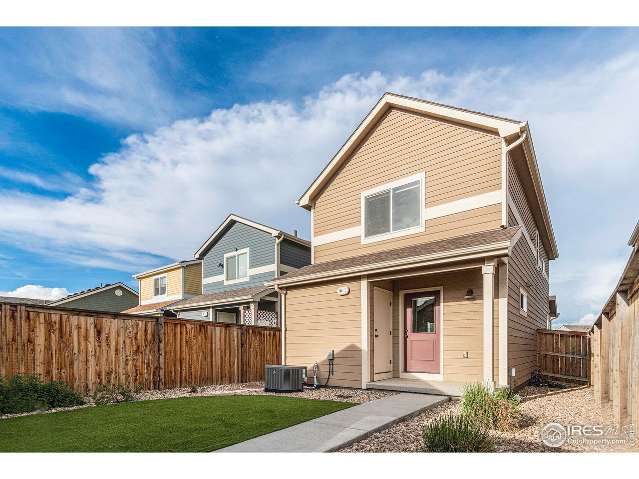 2771 Red Wheat Trail Berthoud, CO 80513 - Photo 21 of 24 a front view of a house with wooden fence