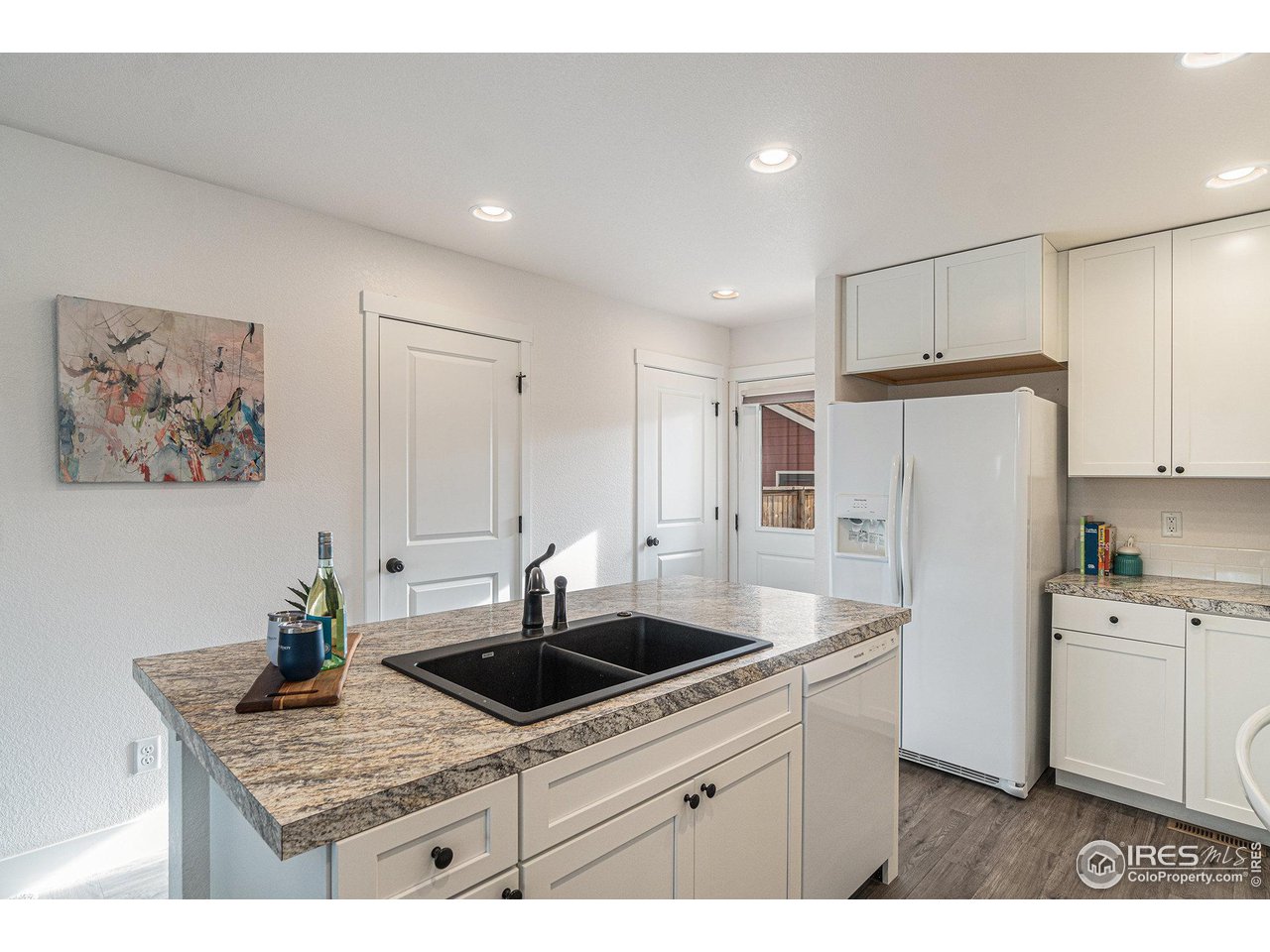 2771 Red Wheat Trail Berthoud, CO 80513 - Photo 6 of 24 a kitchen that has a sink and a stove