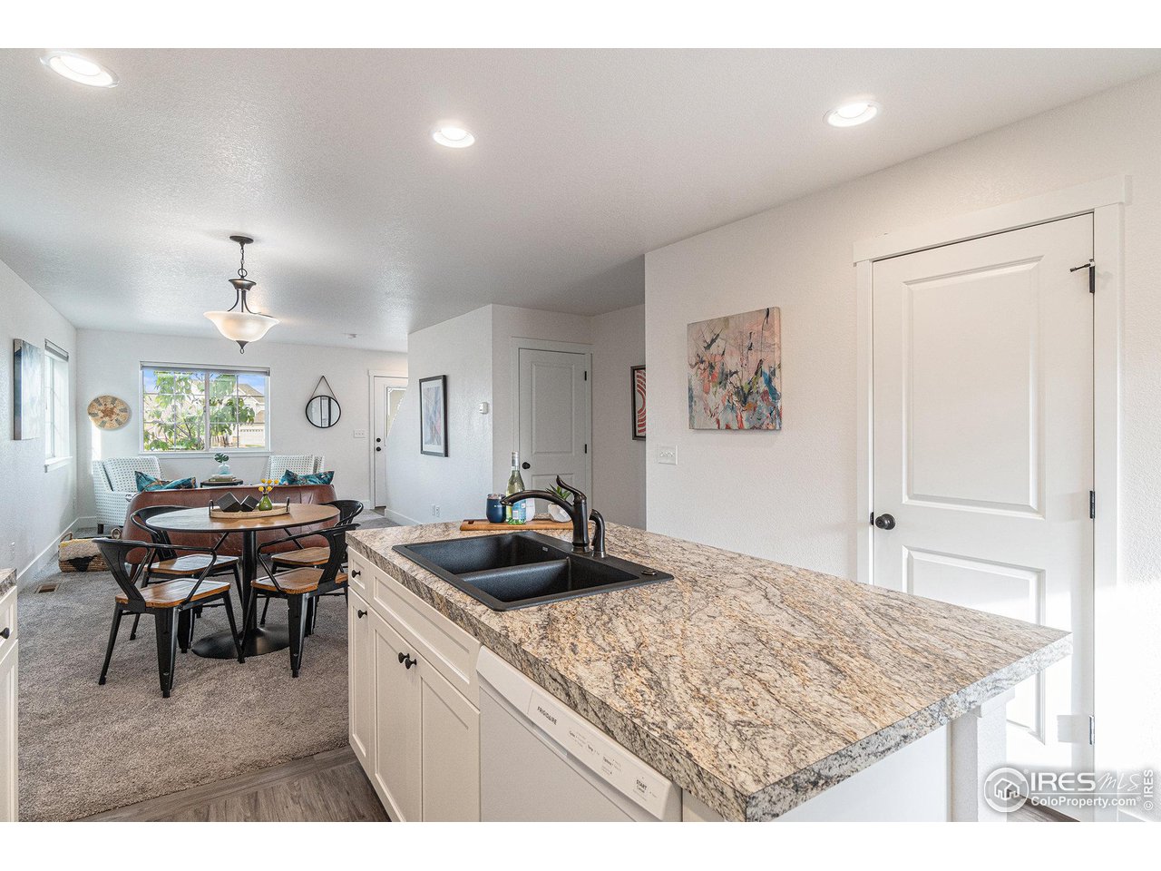 2771 Red Wheat Trail Berthoud, CO 80513 - Photo 7 of 24 a kitchen with a table and chairs