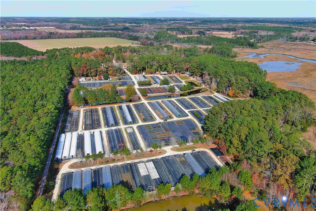 22511 Rose Cottage Road Locustville, VA 23404 - Photo 5 of 34 an aerial view of a house with a garden and lake view
