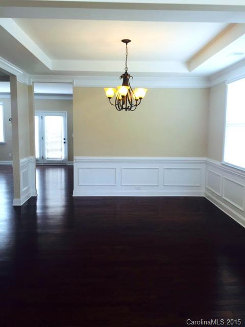 1834 Larkspur Way, Unit 203 Tega Cay, SC 29708 - Photo 2 of 24 a view of an empty room with wooden floor and a window