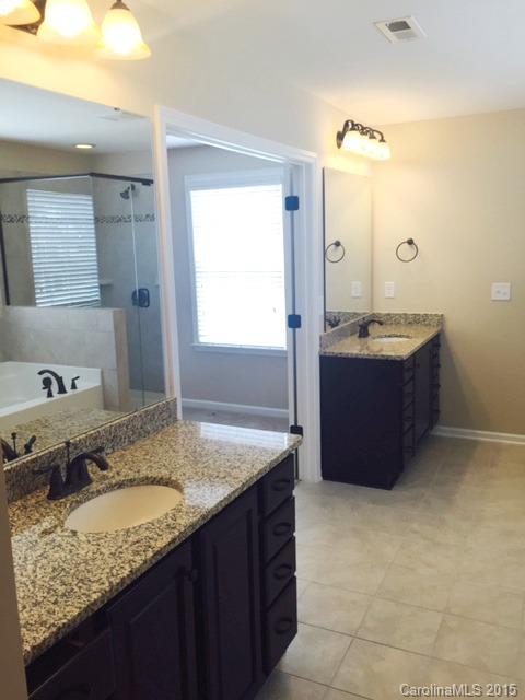 1834 Larkspur Way, Unit 203 Tega Cay, SC 29708 - Photo 7 of 24 a bathroom with a granite countertop sink and a mirror