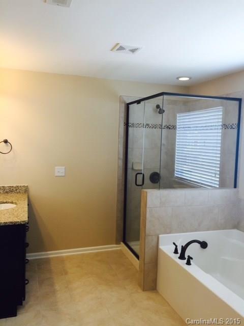 1834 Larkspur Way, Unit 203 Tega Cay, SC 29708 - Photo 8 of 24 a bathroom with a tub and a shower
