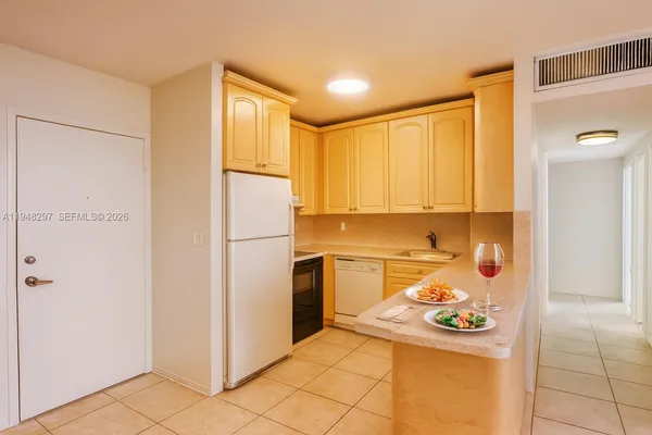 a kitchen with a refrigerator and cabinets