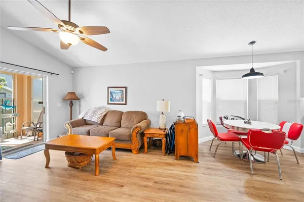 a living room with furniture a rug and a chandelier