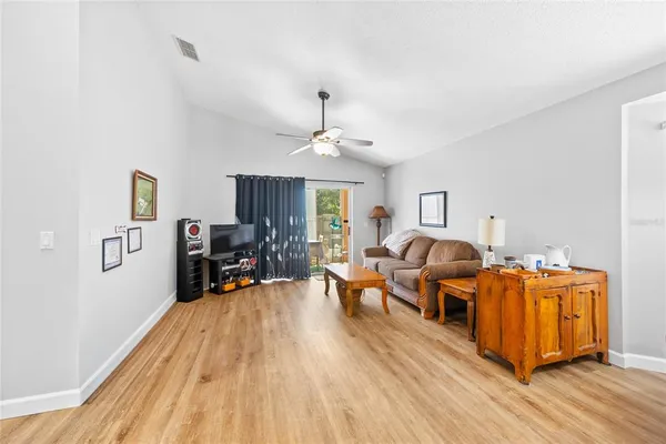 a living room with furniture and a wooden floor