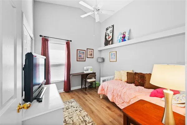 a bedroom with furniture and a flat screen tv