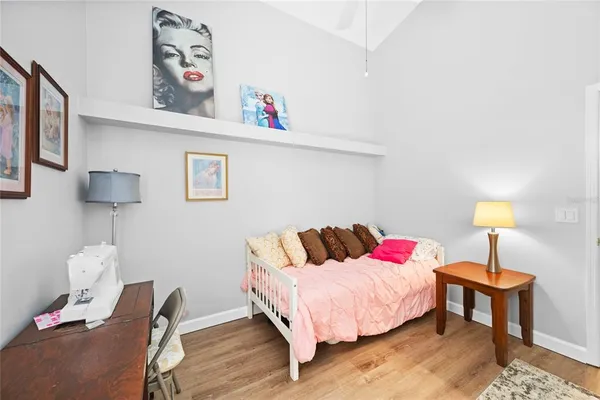 a bedroom with a bed and a lamp on table