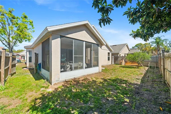 a view of a house with backyard and sitting area