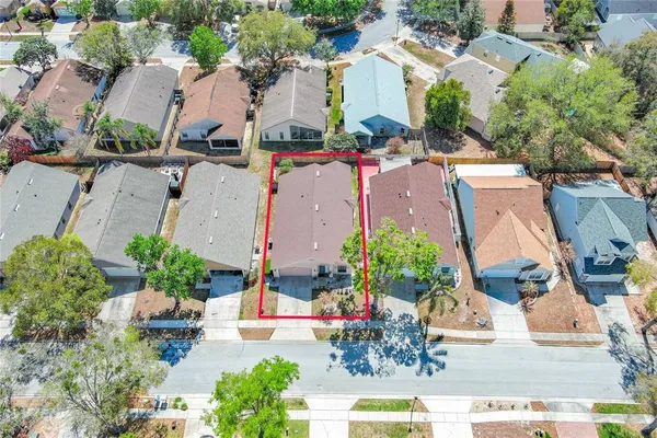 an aerial view of a house with a yard and garden