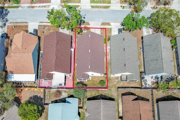 an aerial view of a house with outdoor space and parking
