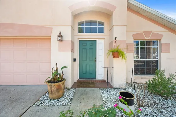 a front view of a house with a potted plant