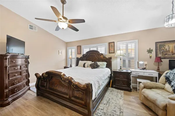 a bedroom with a bed couch and window