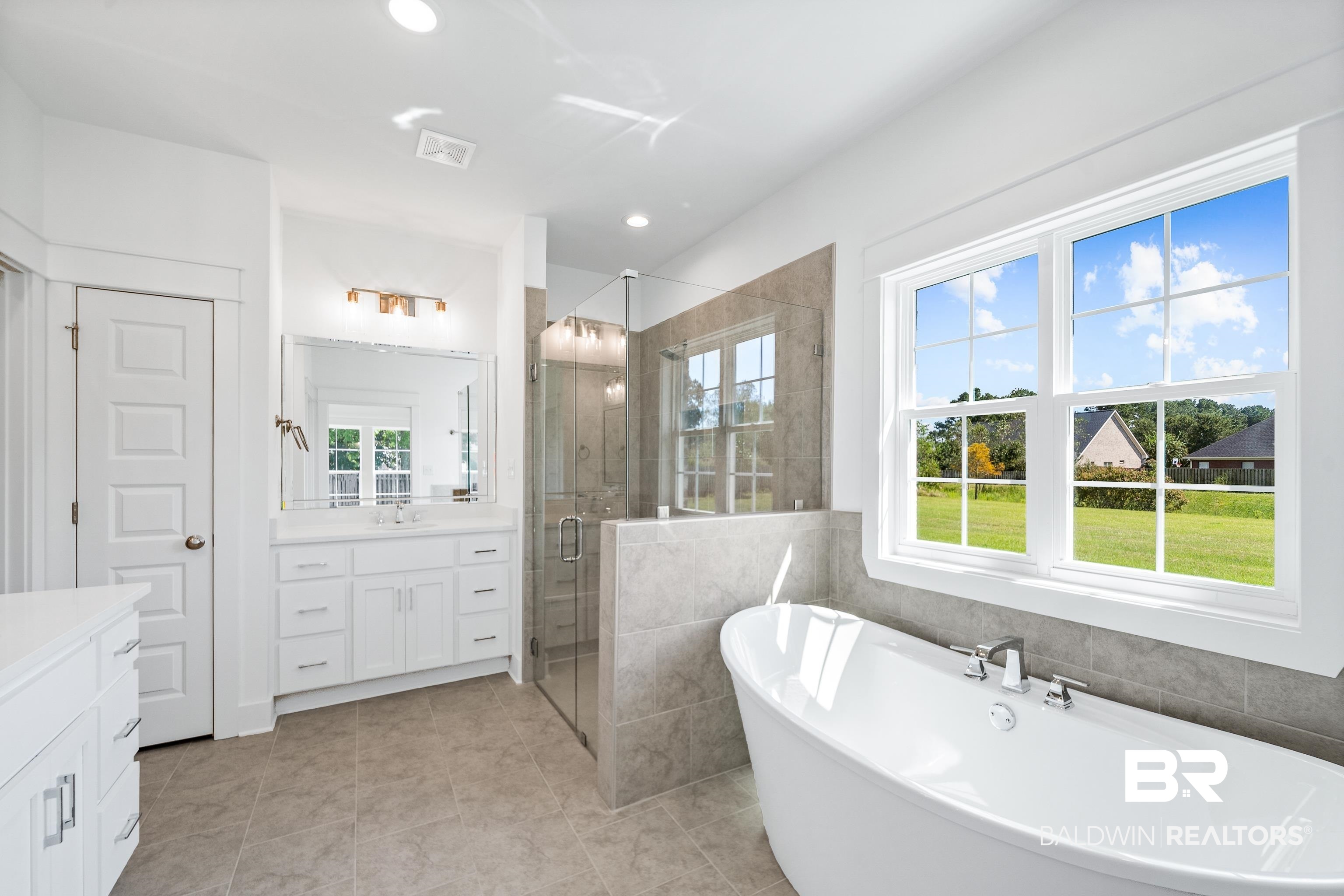 25927 Capra Court Daphne, AL 36526 - Photo 18 of 37 Bathroom featuring a healthy amount of sunlight, shower with separate bathtub, vanity, and tile patterned floors