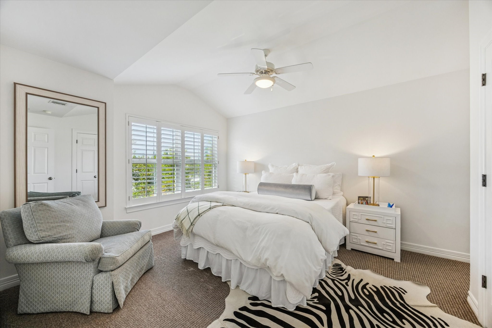 2700 Wroxton Road West University Place, TX 77005 - Photo 18 of 32 a spacious bedroom with a bed a couch and a window