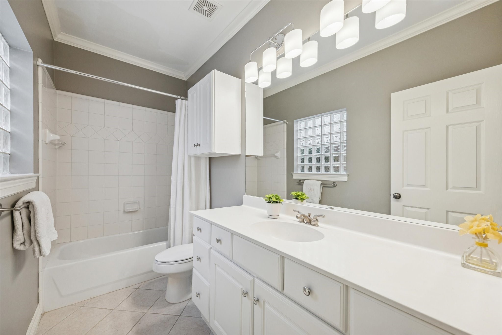 2700 Wroxton Road West University Place, TX 77005 - Photo 8 of 32 a bathroom with a sink a toilet and a mirror