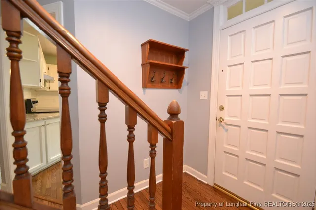 a view of entryway with wooden floor and stairs