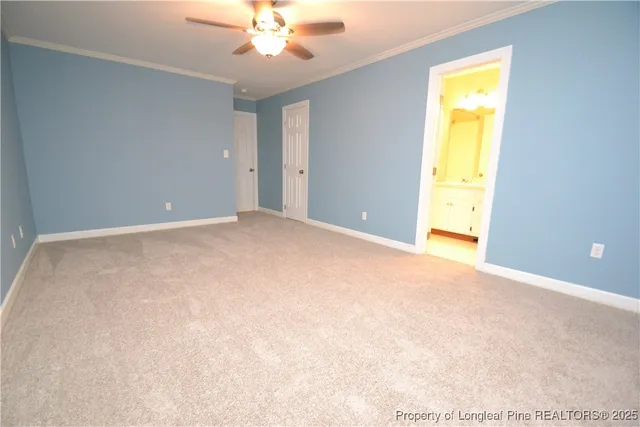an empty room with a ceiling fan and window