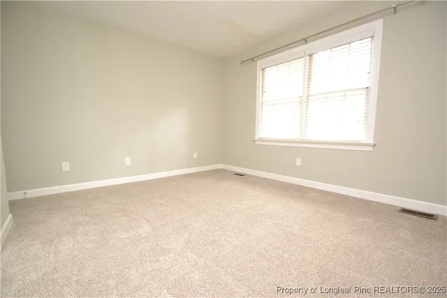 an empty room with sliding glass door