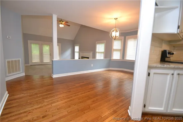 a view of livingroom with kitchen and hardwood
