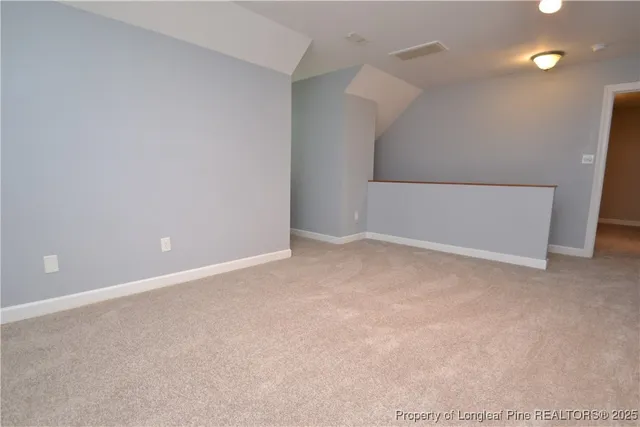 an empty room with a ceiling fan and a window