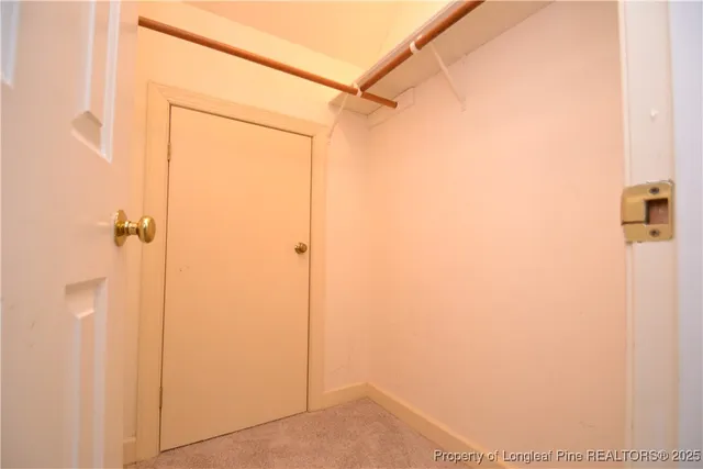 a balcony with wooden floor and trees