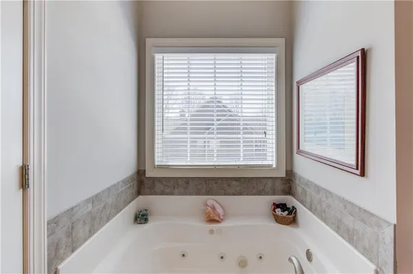 a bath tub sitting in a bathroom next to a window