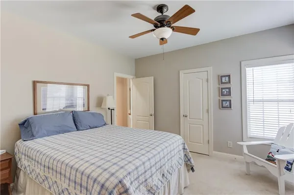 a bedroom with a large bed and a window