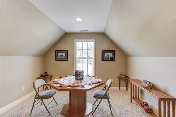 a view of a dining room with furniture and a window