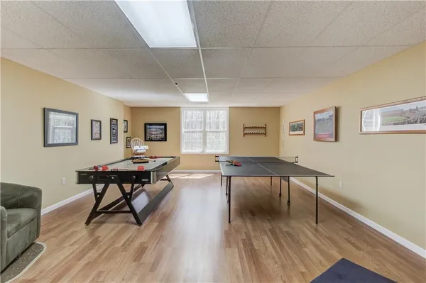 a living room with furniture a table and wooden floor