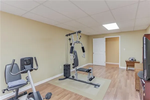 a room with gym equipment and view of living room