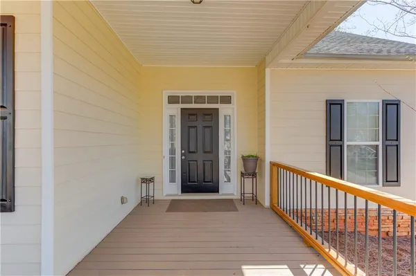 a view of a porch with wooden floor and stairs